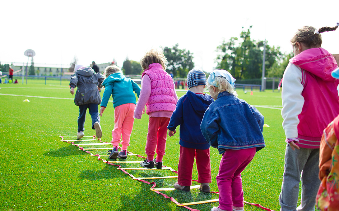 a line of kindergaten students playing on the playground