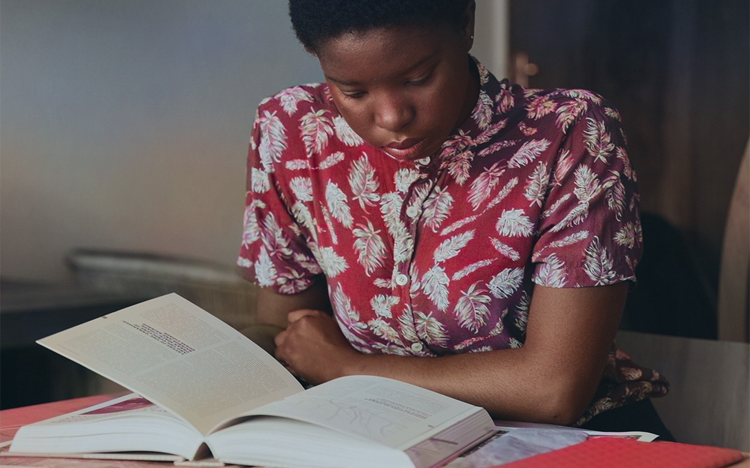 a young African American student reading a book