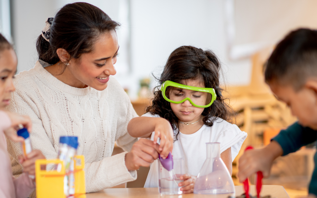Teachers and young students exploring science