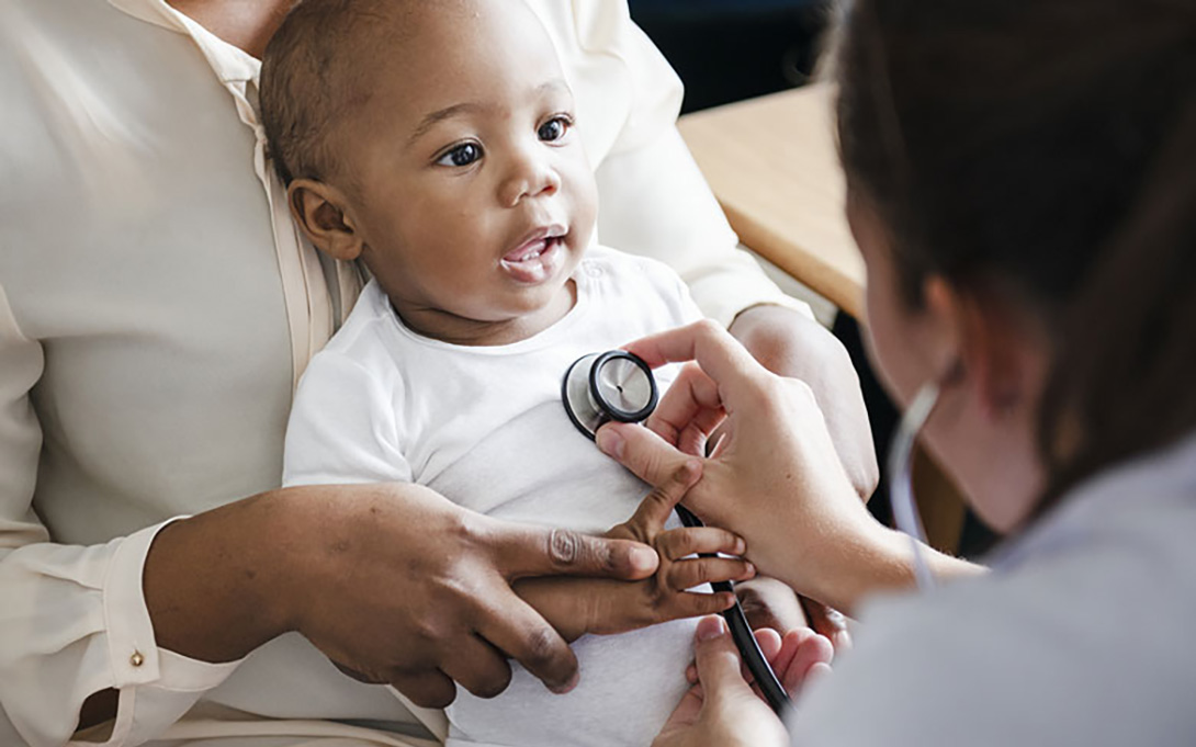 an infant being examined by a pediatrician