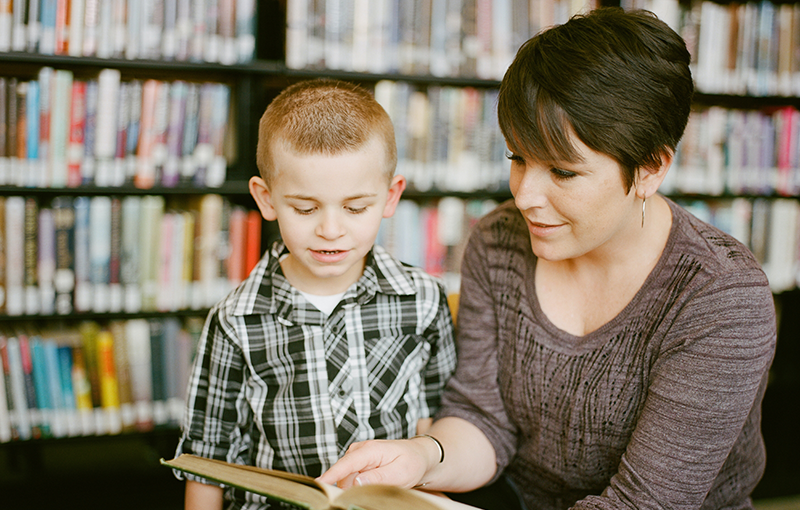 a teacher reading to a young student