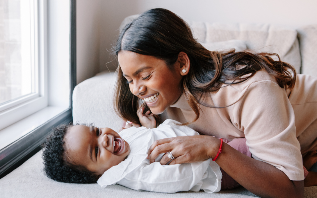 Mom and baby laughing and smiling