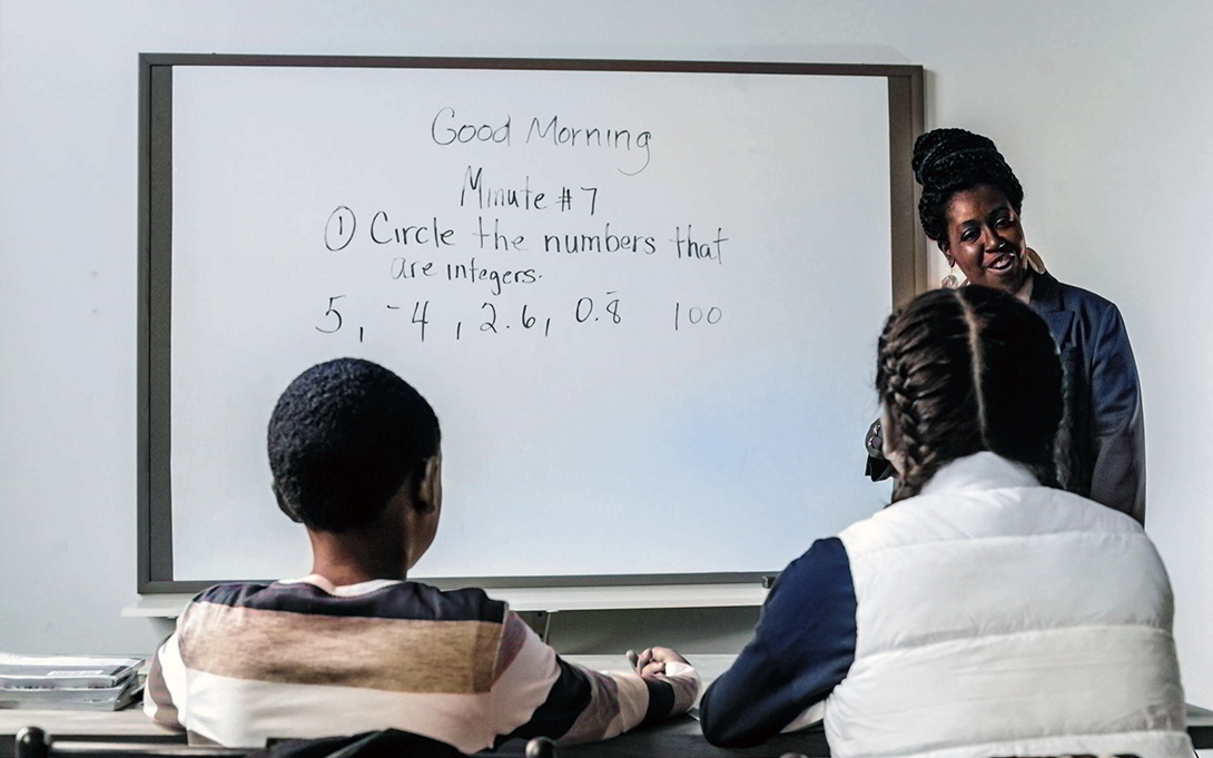 a teacher giving a math lesson to her students