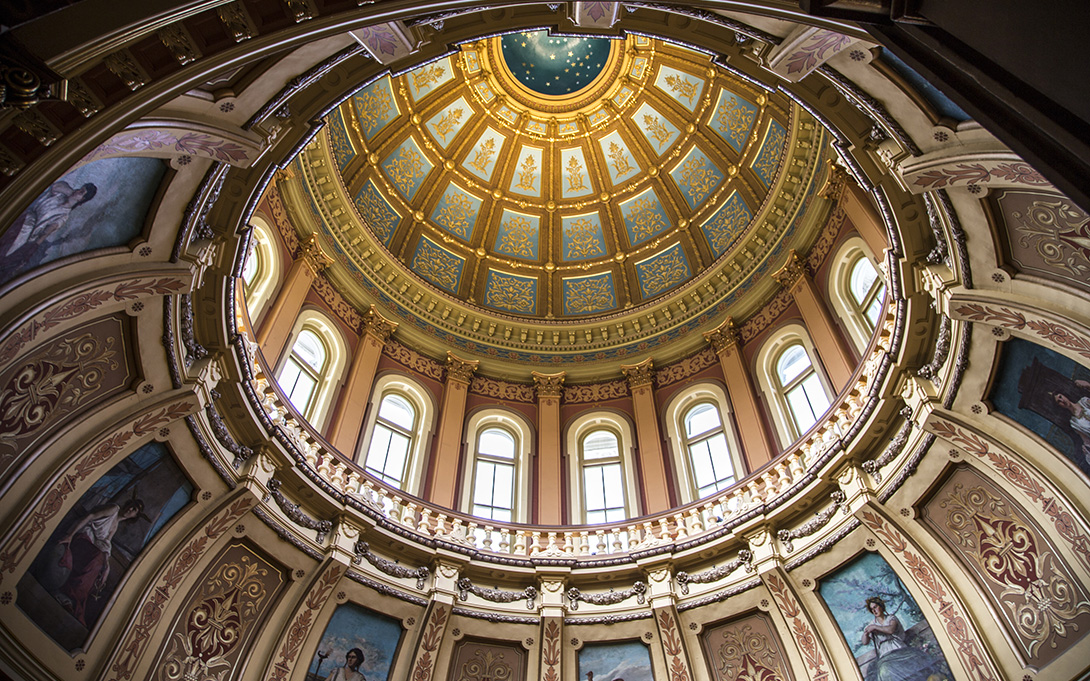the interior image of a dome shaped golden ceiling