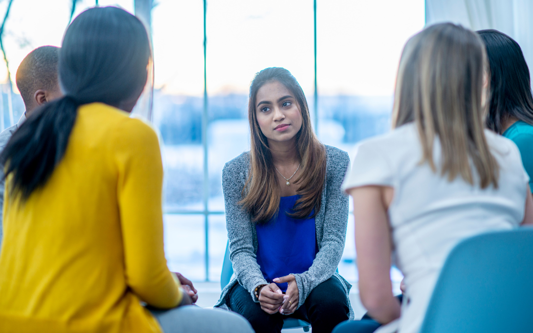 Youth talking with an adult in circle
