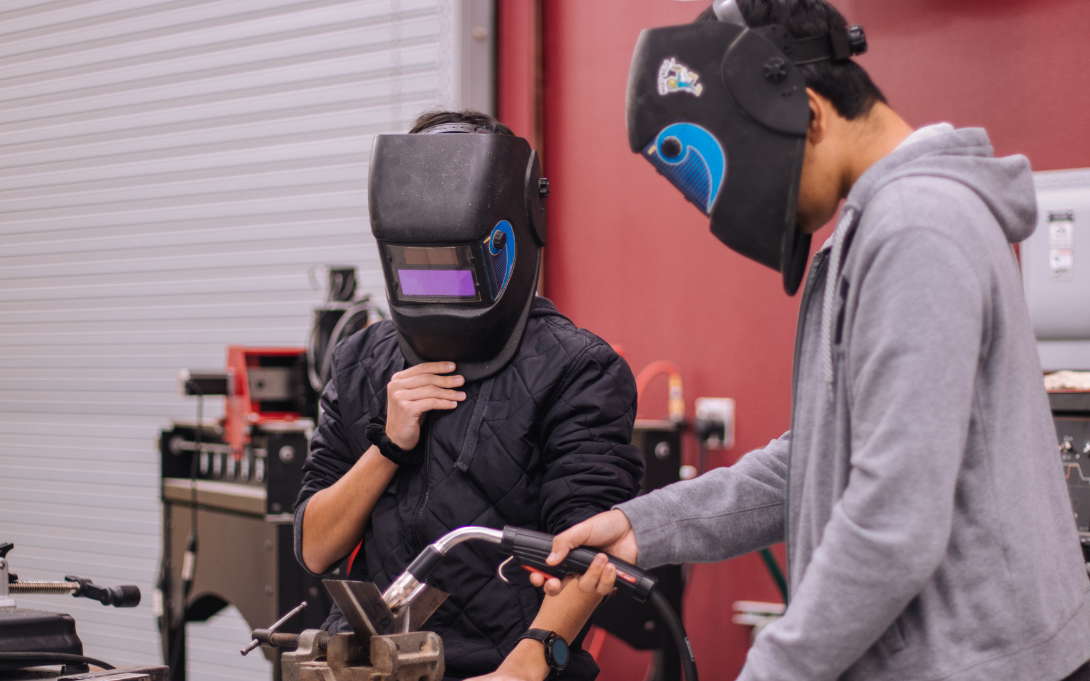 Two students welding