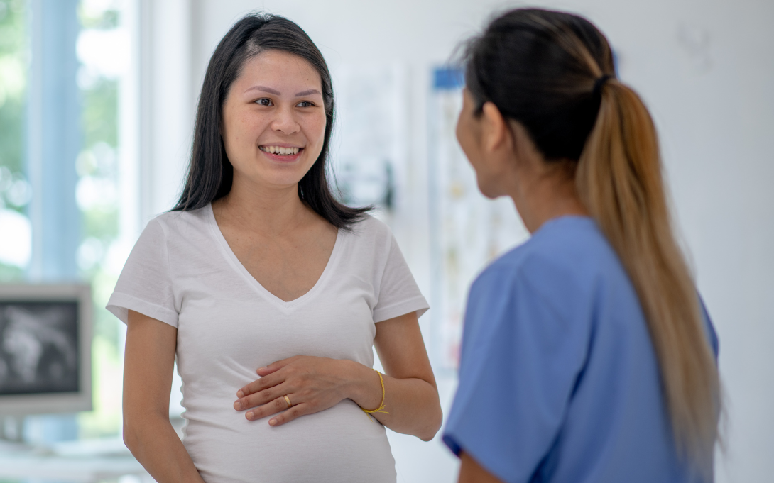 Pregnant person talking to another person