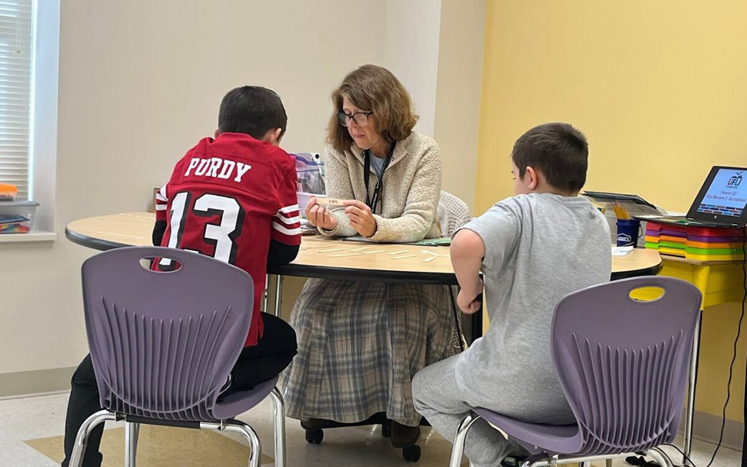 Literacy tutor Lorie Jamison-Phillips works with fourth grade students at Tar River Elementary. Photo Courtesy of Amy Rhyne (Project PI Catherine Asher)
