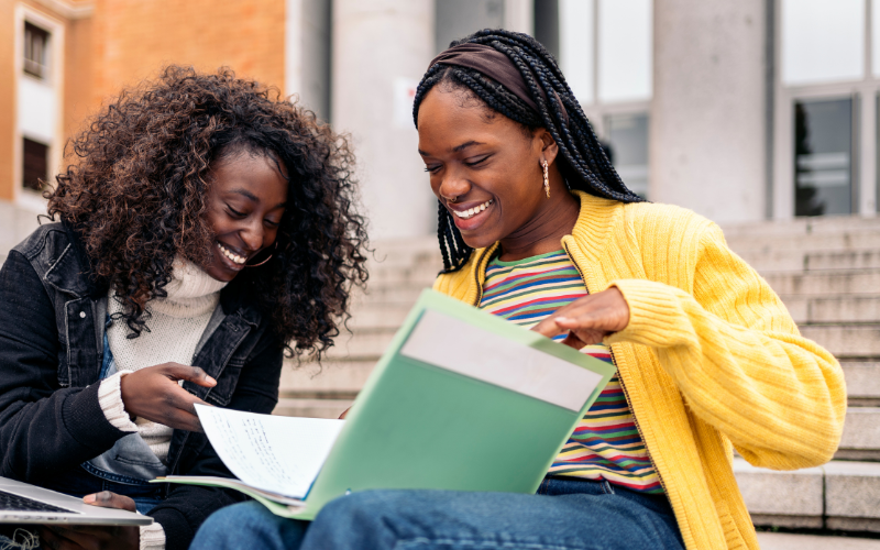 two college students reading together