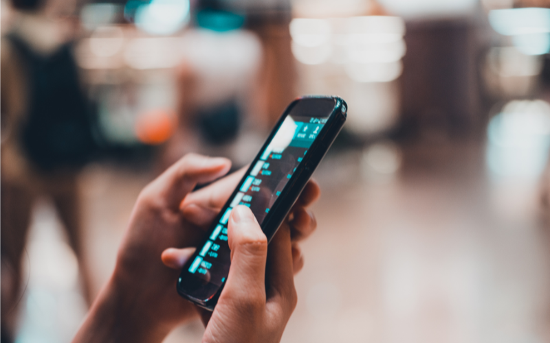 person holding a cell phone with a blurred background