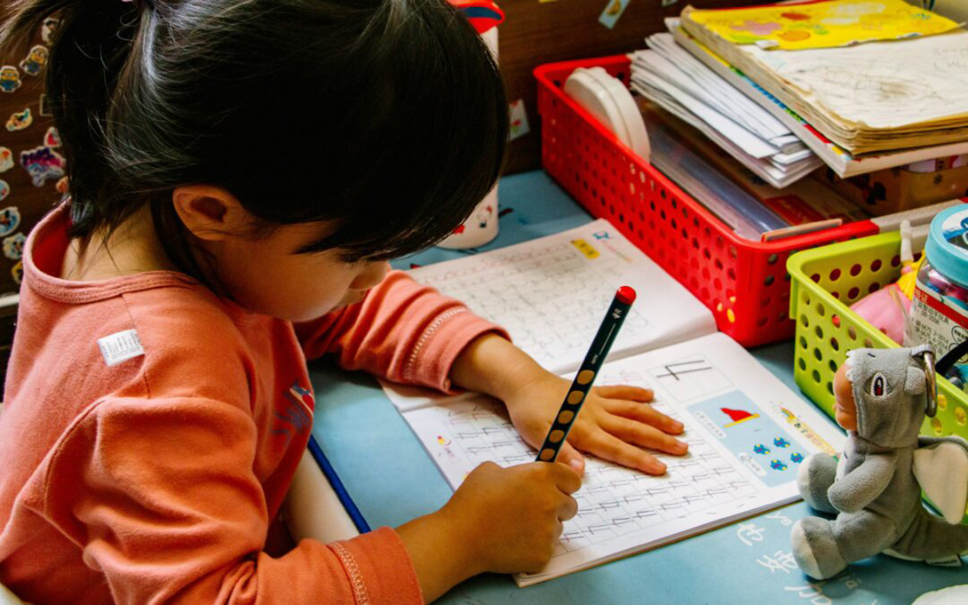 a young child doing math problem in classroom