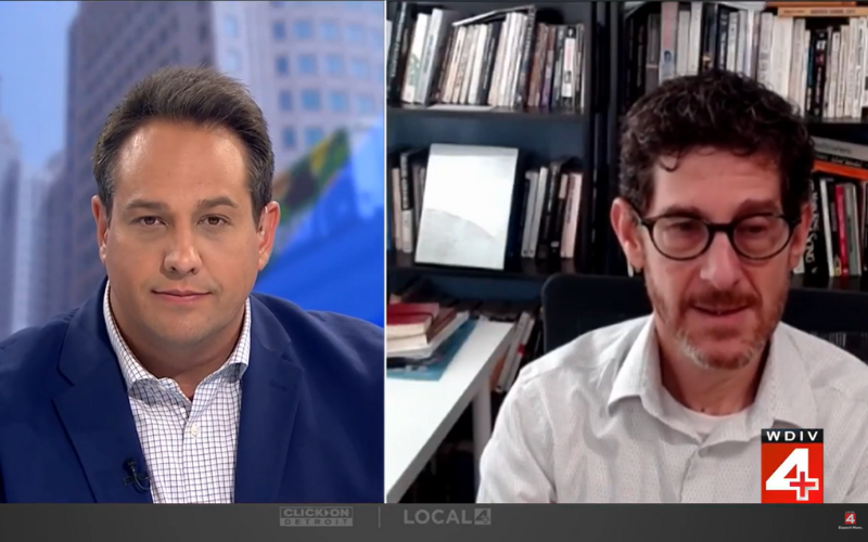 Brian Jacob and news reporter side by side for interview
