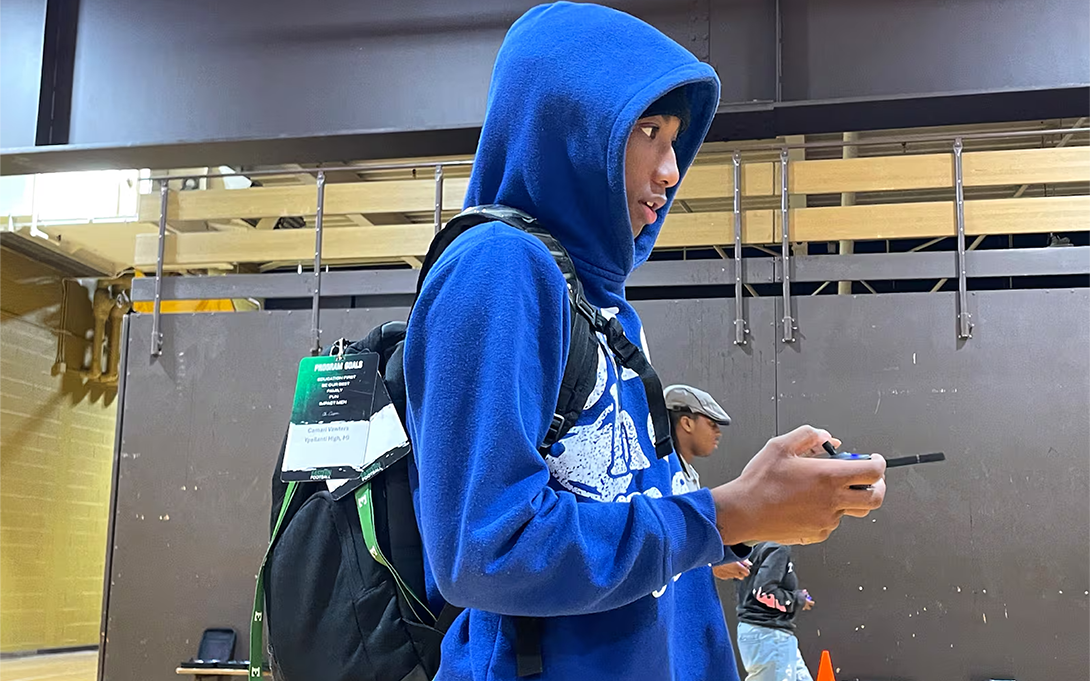 Camari Vawters, a junior at Ypsilanti Community High School, focuses as he directs his drone through an obstacle course, part of an activity in the school’s drone aviation class on Thursday, October 9, 2025. 