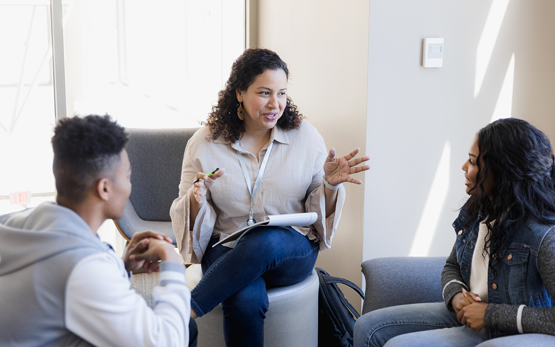 Thumbnail: two high school students talking to a school counselor