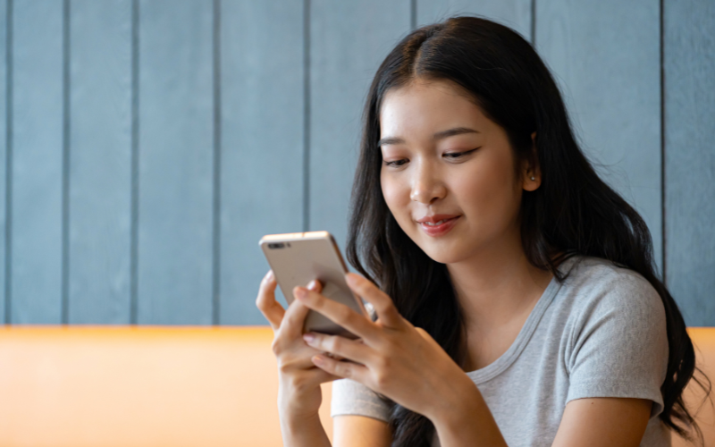 Young woman looking at her phone