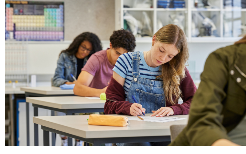 classroom of students at desks taking tests