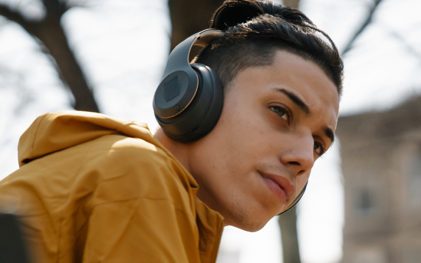 Teen sitting on bench with headphones on