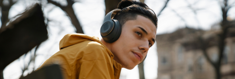 Teen sitting on bench with headphones on