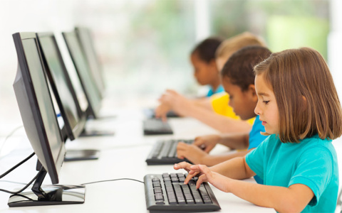 young students using computers in class