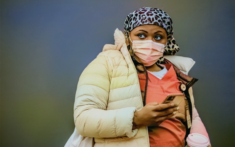 a healthcare working looking away from her cellphone