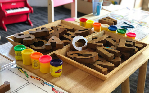 playdouph and block letters on a desk